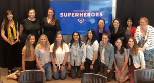 FleishmanHillard Austin Colleagues with super heroes slide in background