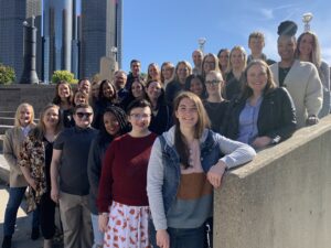 Colleagues from Detroit office outside standing on stairs on sunny day